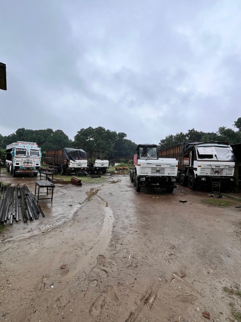 Truck body factory yard with chassis and materials